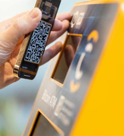 Customer scanning a wallet QR code at a CoinFlip bitcoin ATM location
